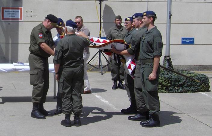 Dr. Spörker affixing the battle streamer with Brig. Jocham and Col. Gutmann